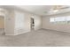 Bright loft area with neutral carpet, a ceiling fan, and a view of the window at 7867 Horse Ferry Rd, Orlando, FL 32835