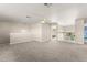 Large loft with neutral carpeting, a ceiling fan, and a view of the downstairs at 7867 Horse Ferry Rd, Orlando, FL 32835