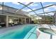 Large screened-in pool and spa area with ample seating for outdoor entertaining at 7867 Horse Ferry Rd, Orlando, FL 32835