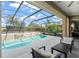 Relaxing screened-in pool area with comfortable lounge seating and well-manicured landscaping at 7867 Horse Ferry Rd, Orlando, FL 32835