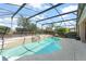 Inviting screened-in pool with integrated spa and lush tropical surroundings at 7867 Horse Ferry Rd, Orlando, FL 32835