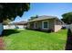 Beautiful backyard with a lush lawn, white fence, landscaping, and a play structure at 8037 Bangle Ln, Orlando, FL 32836