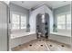Stylish bathroom with a large soaking tub and adjacent glass enclosed shower at 8037 Bangle Ln, Orlando, FL 32836
