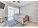 Cozy bedroom features a ceiling fan and sliding glass door to the lanai at 8037 Bangle Ln, Orlando, FL 32836