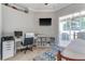 Cozy bedroom features a ceiling fan, desk, and sliding glass door to the lanai at 8037 Bangle Ln, Orlando, FL 32836