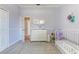 Bright Bedroom featuring a crib, changing table, pastel color scheme, and cozy carpet for a warm ambiance at 8037 Bangle Ln, Orlando, FL 32836
