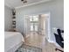 Cozy bedroom features a ceiling fan, desk, and view of foyer at 8037 Bangle Ln, Orlando, FL 32836