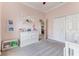 Bedroom showcasing soft pink walls, plush carpeting, and a large window filling the room with natural light at 8037 Bangle Ln, Orlando, FL 32836
