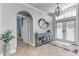 Bright foyer features tile floors, an arched doorway, and a decorative table at 8037 Bangle Ln, Orlando, FL 32836