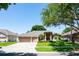 Beautiful single-story home with a three-car garage and well-manicured lawn at 8037 Bangle Ln, Orlando, FL 32836