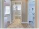 Open hallway displaying access to multiple rooms and a bathroom with stylish tiled flooring and neutral paint at 8037 Bangle Ln, Orlando, FL 32836