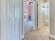 Hallway offering access to a bedroom and bathroom with tiled floors that seamlessly connect each space at 8037 Bangle Ln, Orlando, FL 32836