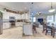 Bright, open kitchen featuring white cabinets, granite countertops, stainless steel appliances, and a breakfast bar at 8037 Bangle Ln, Orlando, FL 32836
