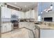 Updated kitchen with white cabinets, granite countertops, stainless steel appliances, and tile backsplash at 8037 Bangle Ln, Orlando, FL 32836