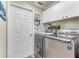 Well-organized laundry room with modern appliances, storage cabinets, and a clean, efficient design at 8037 Bangle Ln, Orlando, FL 32836