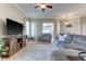 Inviting living room featuring a large TV, cozy furniture, and a sliding glass door for indoor/outdoor living at 8037 Bangle Ln, Orlando, FL 32836