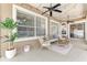 Serene screened lanai featuring cozy seating, a ceiling fan, and tranquil outdoor views at 8037 Bangle Ln, Orlando, FL 32836