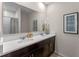 Bathroom featuring a double vanity with white countertops and stylish dark wood cabinetry at 976 Commons Way, Port Orange, FL 32129