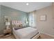 This bedroom features a queen size bed and an eye-catching accent wall at 976 Commons Way, Port Orange, FL 32129