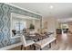 Bright dining room showcases an elegant table setting and a large decorative mirror at 976 Commons Way, Port Orange, FL 32129