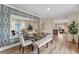 Formal dining room featuring stylish wallpaper and a modern bench and chairs at 976 Commons Way, Port Orange, FL 32129
