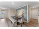 Open concept dining area with modern furniture and a decorative wall mirror at 976 Commons Way, Port Orange, FL 32129