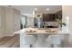 Kitchen with a large island and stainless steel appliances next to view of dining area at 976 Commons Way, Port Orange, FL 32129