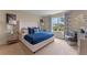 Serene main bedroom with a large window, soft carpet, and coordinated blue bedding at 976 Commons Way, Port Orange, FL 32129