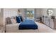 Comfortable main bedroom showcasing a plush bed, large window, and elegant furnishings at 976 Commons Way, Port Orange, FL 32129