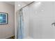 Bright and clean shower with white subway tile and a stylish patterned shower curtain at 976 Commons Way, Port Orange, FL 32129
