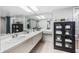 Bright bathroom with double sinks, neutral tile floors and decor and ample storage space at 1000 Winderley Pl # 140, Maitland, FL 32751