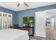 Bedroom featuring a TV, wood floors, and an open door to the living area at 1000 Winderley Pl # 140, Maitland, FL 32751