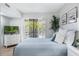 Comfortable bedroom features a view through folding shutters, as well as a serene color palette at 1000 Winderley Pl # 140, Maitland, FL 32751