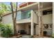Inviting condo entrance featuring a blue railing balcony, dual front doors adorned with wreaths, and a cozy seating area at 1000 Winderley Pl # 140, Maitland, FL 32751