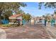 Community entrance featuring a guardhouse and a bright blue gate with lush landscaping at 1000 Winderley Pl # 140, Maitland, FL 32751