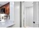Bright kitchen view next to hallway, with a large quartz countertop and modern appliances at 1000 Winderley Pl # 140, Maitland, FL 32751