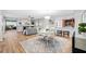 Open-concept living area with a dining table and a view into the kitchen at 1000 Winderley Pl # 140, Maitland, FL 32751
