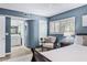 Stylish main bedroom with an upholstered chair, wood floors, and an ensuite bathroom at 1000 Winderley Pl # 140, Maitland, FL 32751
