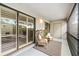 Relax on the screened porch with comfortable seating, providing a peaceful retreat with views and privacy at 1000 Winderley Pl # 140, Maitland, FL 32751
