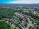 A high angle view showcases rooftops and a serene pond nestled within a green residential neighborhood at 141 Campanello Ct, Daytona Beach, FL 32117