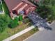 Aerial view of the house showcasing its well-manicured lawn, exterior, and front patio with umbrella-covered seating at 141 Campanello Ct, Daytona Beach, FL 32117