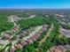 Expansive aerial view of a residential community featuring tree-lined streets and scenic ponds at 141 Campanello Ct, Daytona Beach, FL 32117