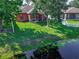 View of the backyard and covered screened patio overlooking a pond and lush greenery at 141 Campanello Ct, Daytona Beach, FL 32117