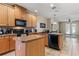 Well-lit kitchen featuring wood cabinets, granite countertops, and stainless steel appliances at 141 Campanello Ct, Daytona Beach, FL 32117