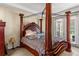 Spacious main bedroom with a four poster bed, and access to an outdoor patio at 141 Campanello Ct, Daytona Beach, FL 32117