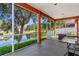 Covered patio with screens offering a serene view of the pond and well maintained backyard at 141 Campanello Ct, Daytona Beach, FL 32117