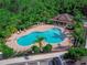 A stunning pool surrounded by lush landscaping with ample seating, perfect for outdoor relaxation and enjoyment at 141 Campanello Ct, Daytona Beach, FL 32117