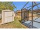 Backyard featuring storage shed and screened-in patio area at 5091 Plymouth Turtle Cir, St Cloud, FL 34772