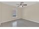 Bright bedroom featuring wood-look flooring and a ceiling fan at 5091 Plymouth Turtle Cir, St Cloud, FL 34772