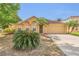 Charming single-story home featuring a well-maintained yard with tropical plants and a two-car garage at 5091 Plymouth Turtle Cir, St Cloud, FL 34772